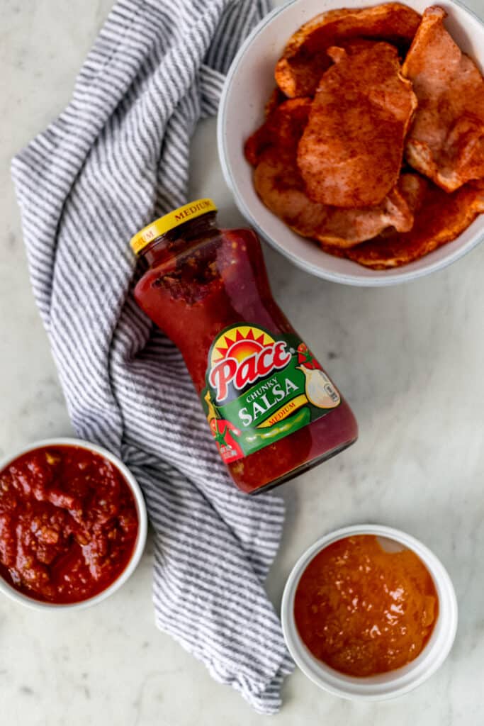 jar of pace salsa with napkin, salsa, peach preserves, and pork chops