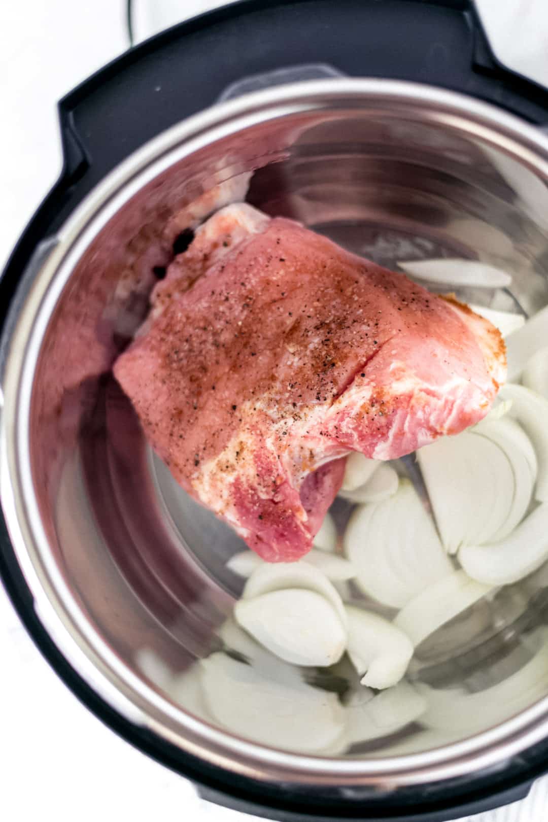 seasoned pork and sliced onion in instant pot 