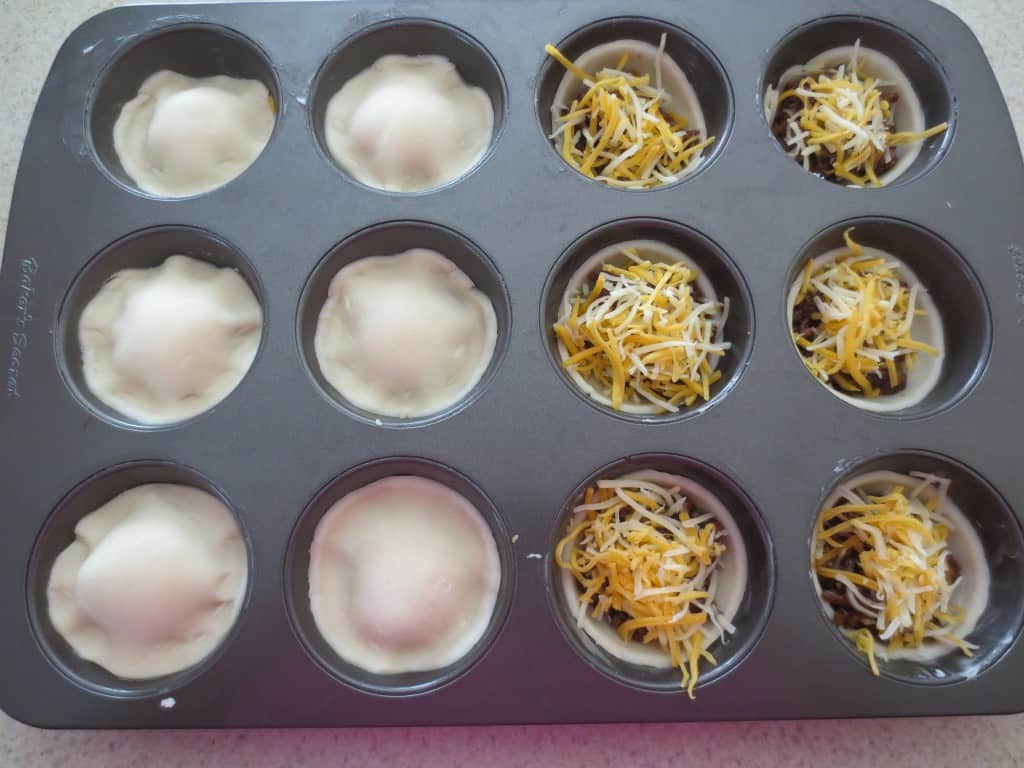 beef pies in process in muffin pan 