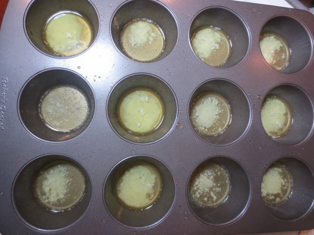overhead view of melted butter in muffin pan for mini peach cobbler recipe