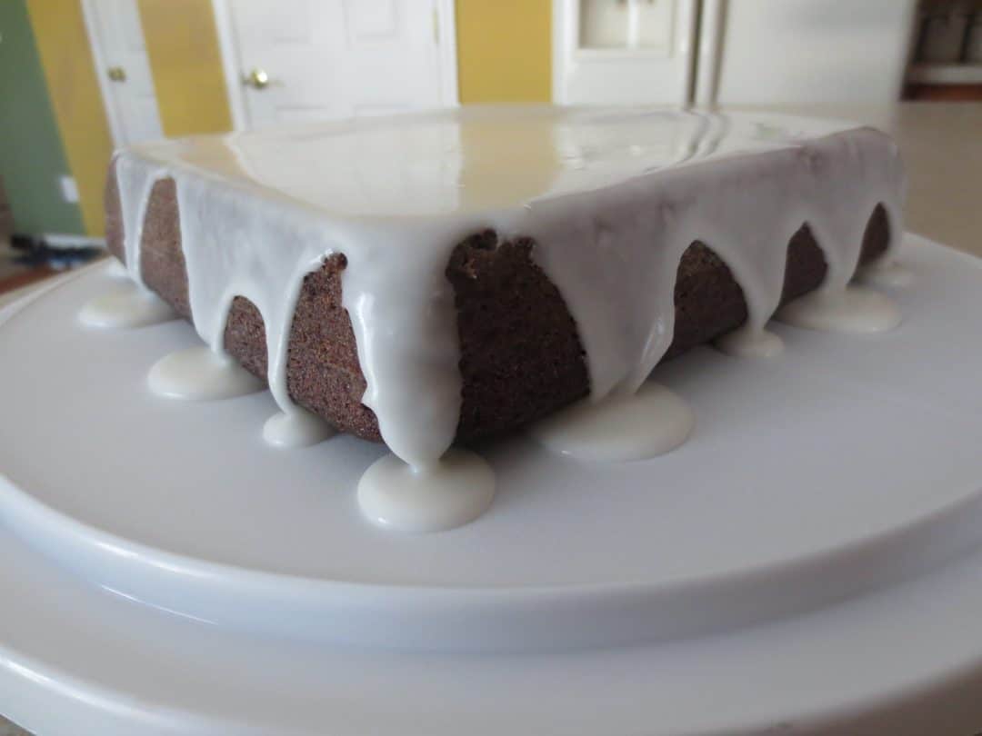 close up side view of finished cake topped with frosting