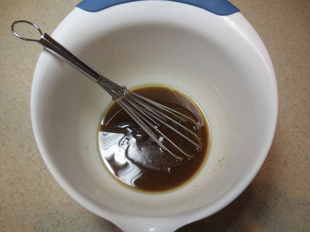 melted butter and brown sugar in large white mixing bowl with whisk 