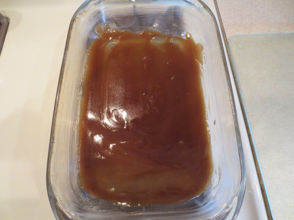 brown sugar mixture spread on the bottom of a glass baking dish 