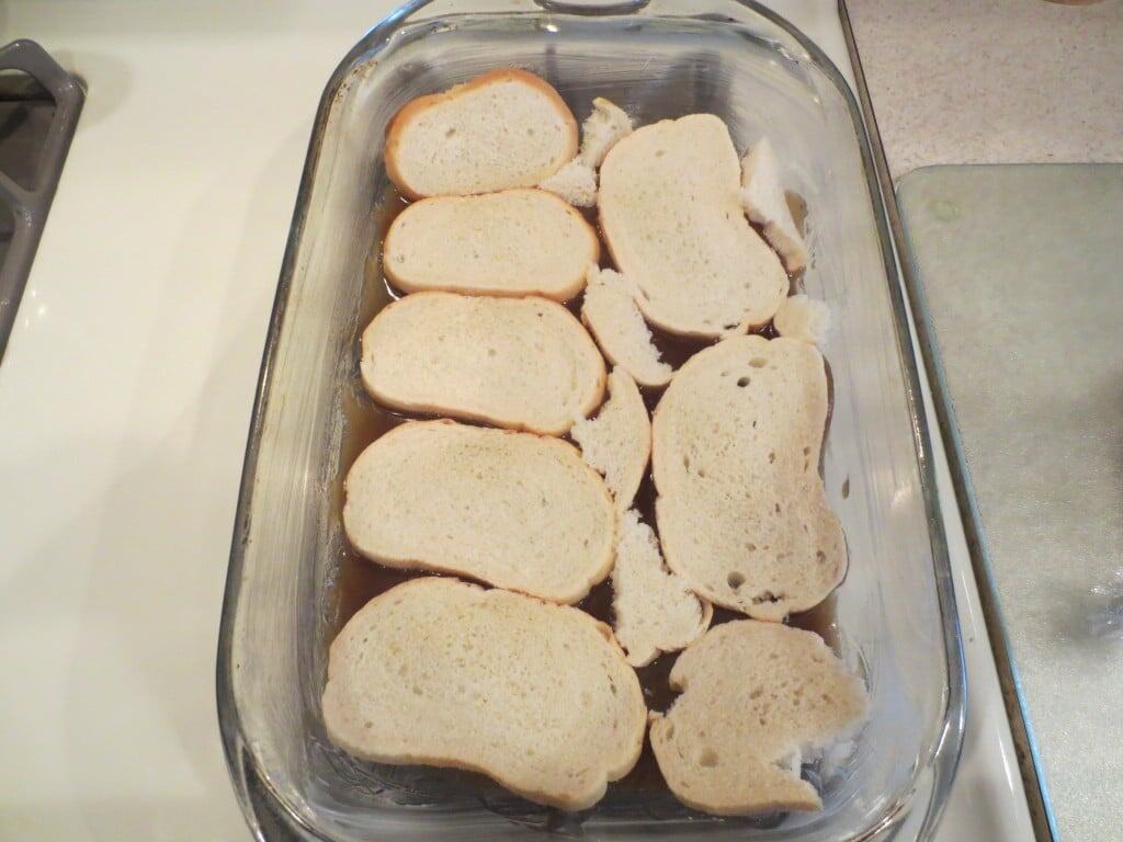 sugar mixture topped with bread in baking dish 