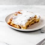 Close up side view of pieces of french toast on white plate.