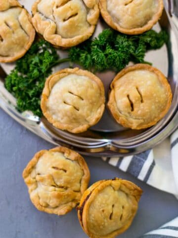 Mini BBQ Beef Pies are the perfect quick and easy dinner that the whole family will love. Tasty beef, cheese, sauce, wrapped in pie crust is so delicious. simplylakita.com