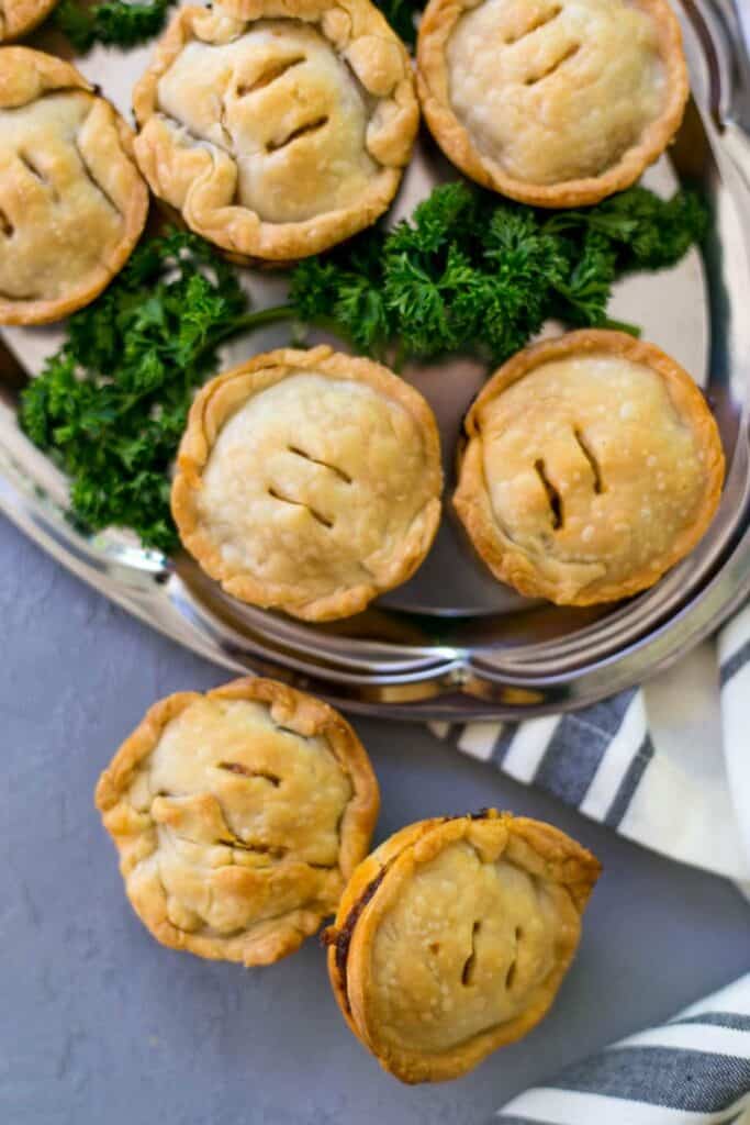 overhead view of finished bbq pies on silver platter with parsley