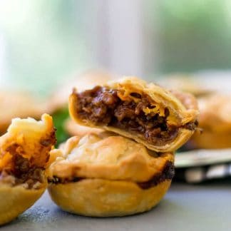 close up side view of two pies stacked on top of each other with one cut in half