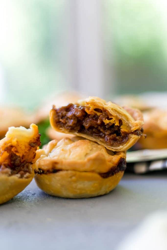 close up side view of two pies stacked on top of each other with one cut in half
