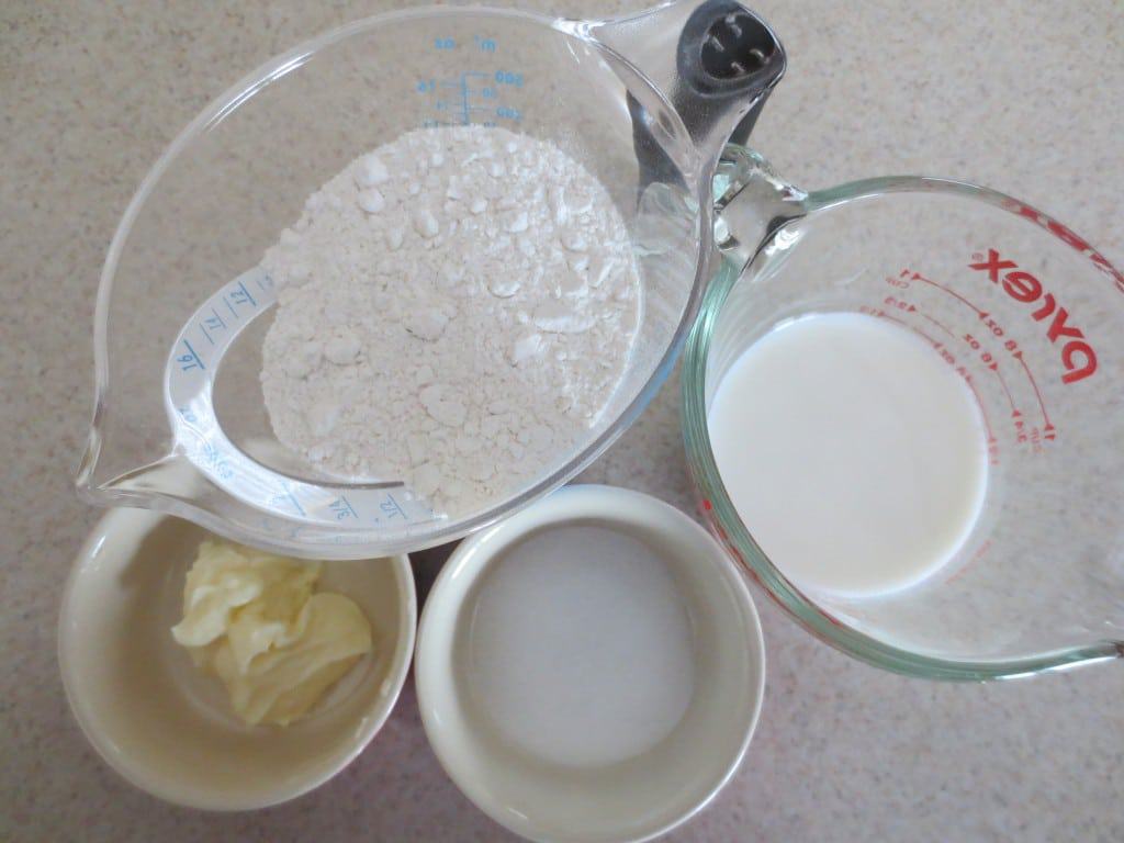 ingredients measured out for fast and easy biscuits in containers on counter