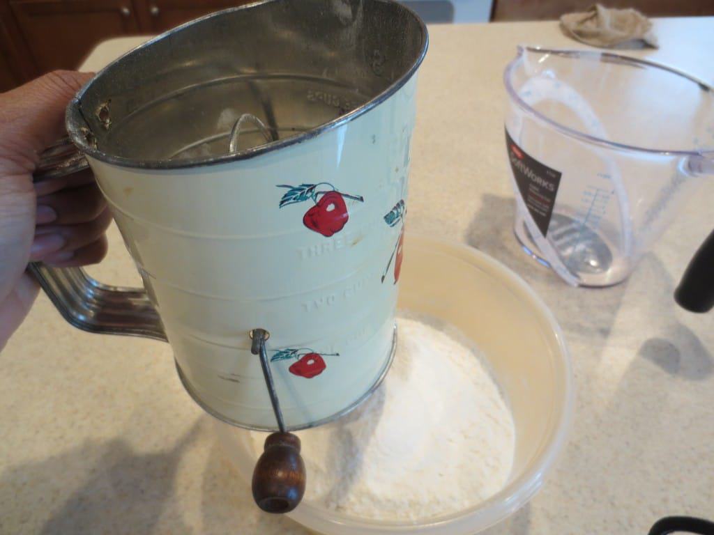 sifting flour into bowl 