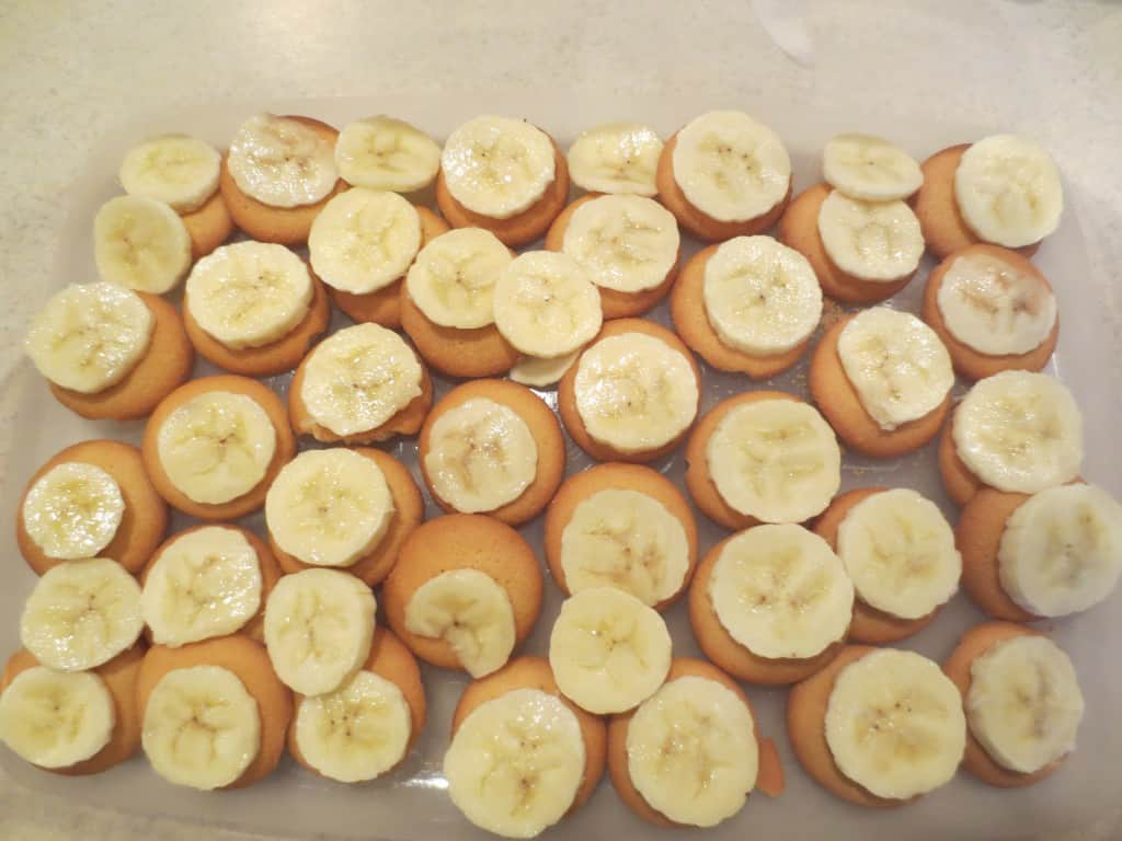 wafers topped with banana slices in baking dish 