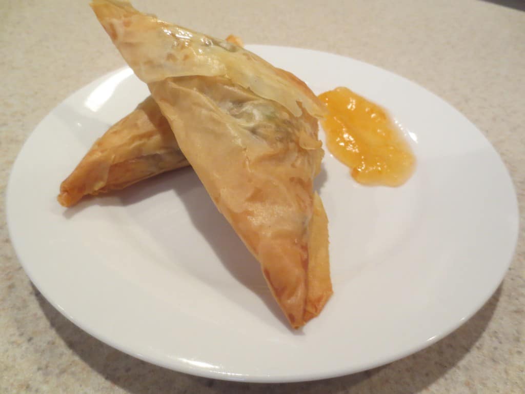 close up side view of samosas on plate 