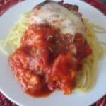 white plate of finished chicken parm with spaghetti