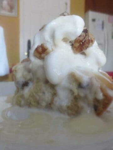 close up side view of blondies topped with ice cream and sauce