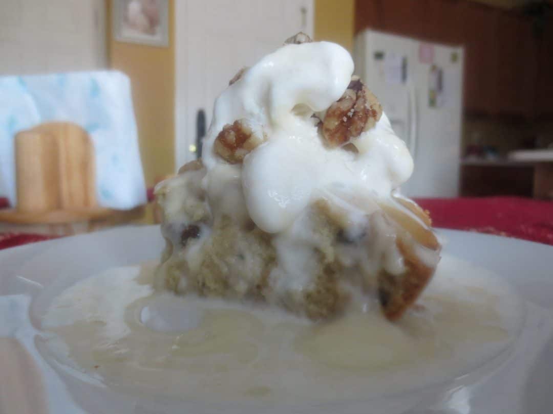 close up side view of blondies topped with ice cream and sauce
