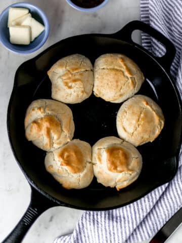 overhead view six biscuits in cast iron skillet