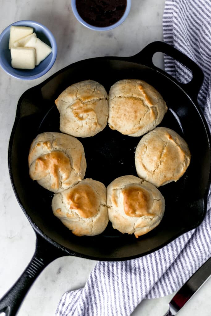 overhead view six biscuits in cast iron skillet 