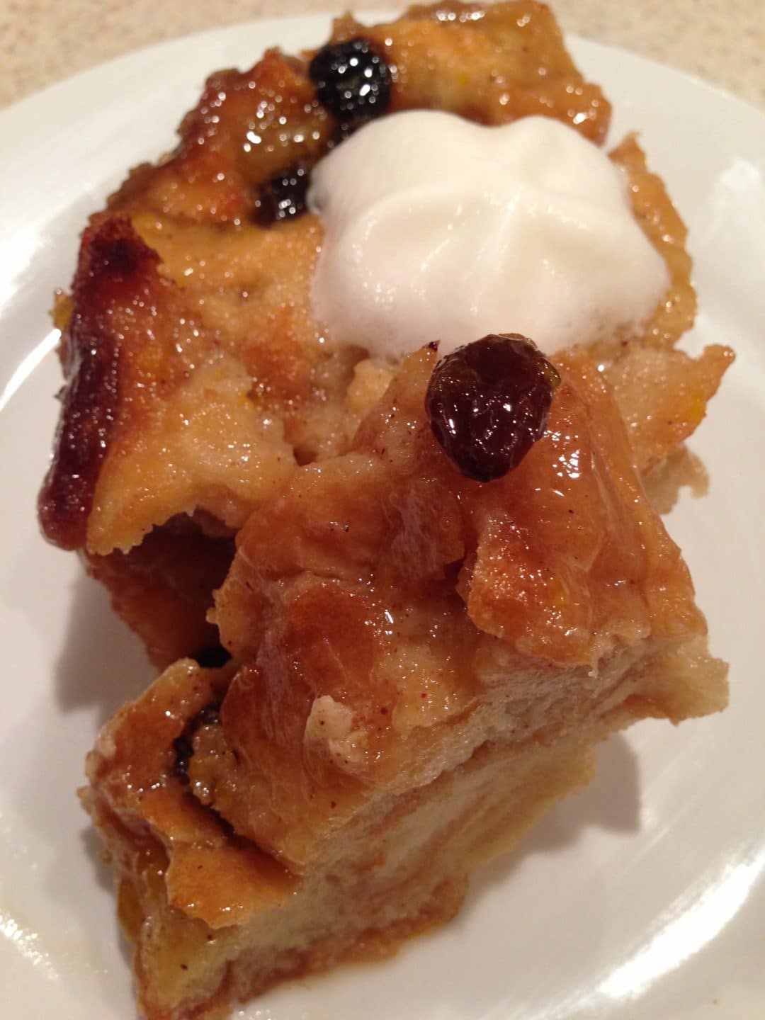 Bread Pudding with Brown Sugar Sauce is a sweet and delicious treat that is perfect when made with crusty bread and few ingredients. Topped with a brown sugar sauce that makes it extra tasty. simplylakita.com #breadpudding #dessert