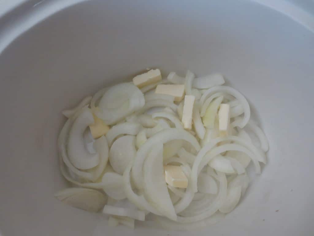 onion and butter added to slow cooker 
