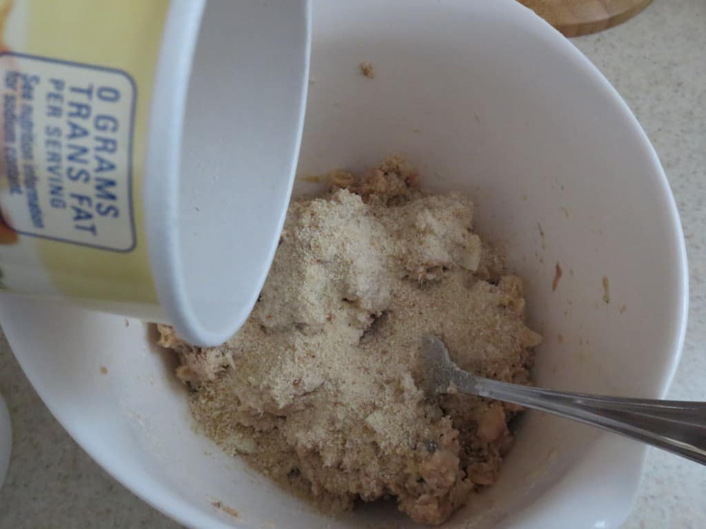 bread crumbs added to white mixing bowl