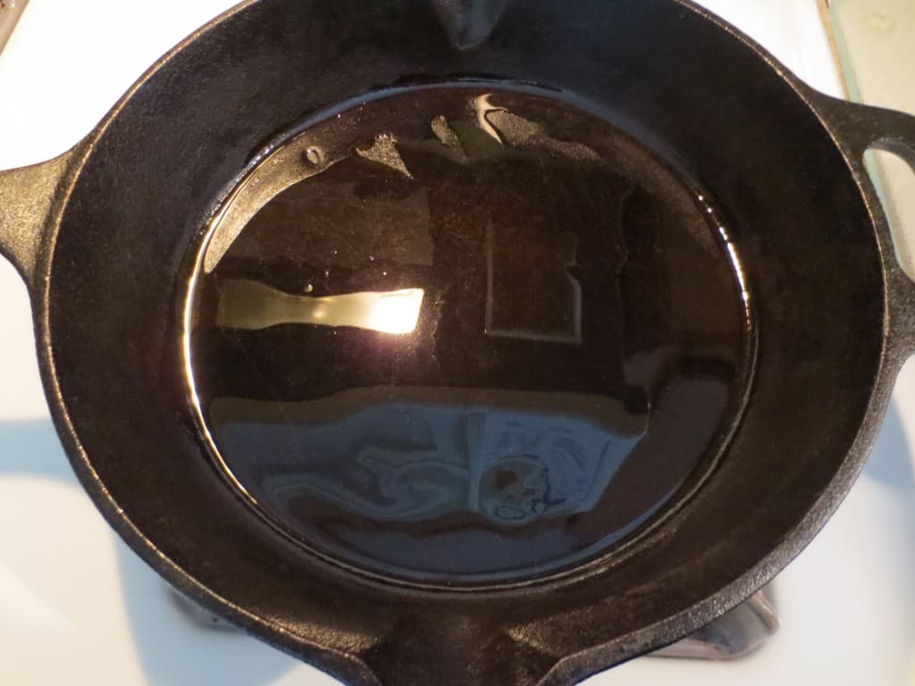 Oil added to a cast iron skillet