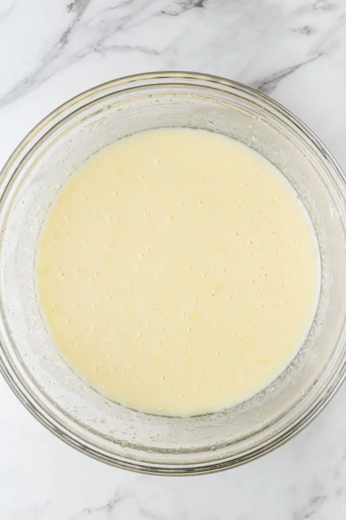 yogurt, sugar, eggs, lemon zest, vanilla and oil combined in glass mixing bowl