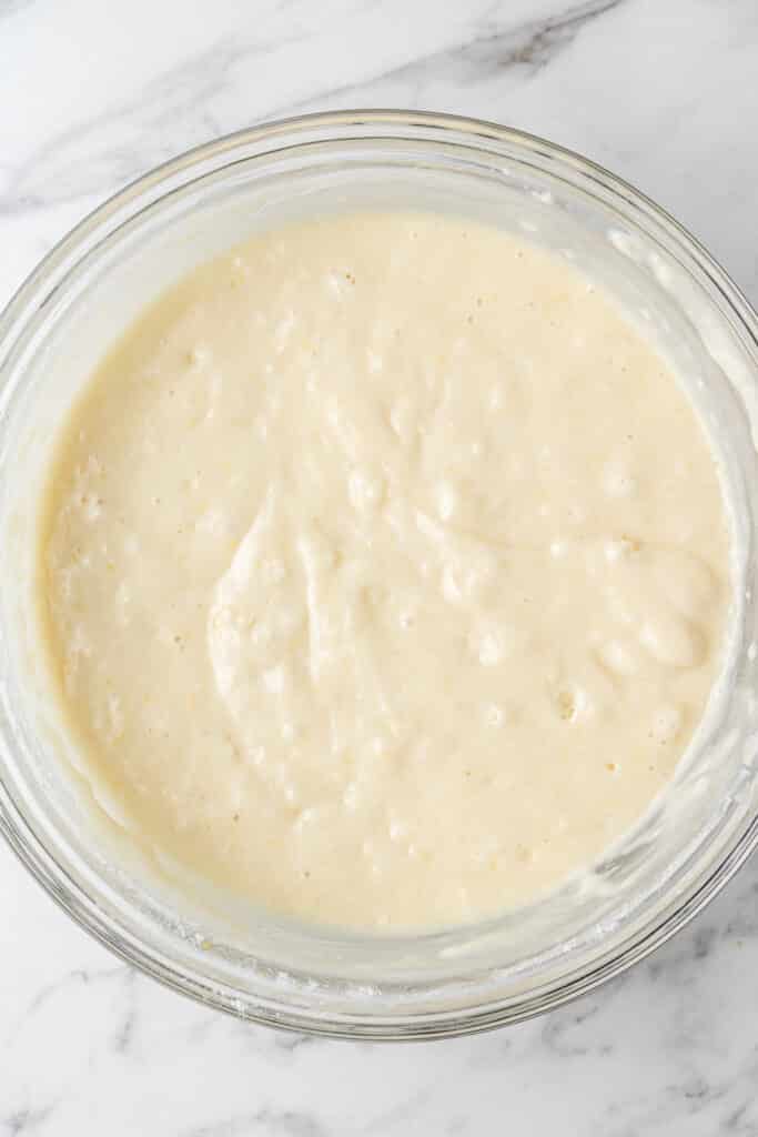 wet and dry ingredients combined in glass mixing bowl for lemon bread 