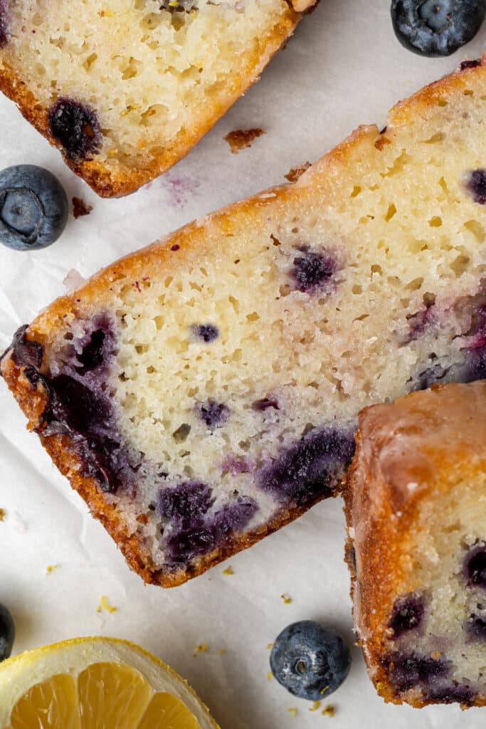 slices on lemon blueberry bread on parchment paper 