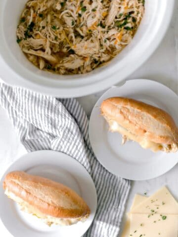 Philly Cheese Chicken Sandwich is cooked in a slow cooker and is the perfect recipe to feed a hungry family on the go. Meaty, Cheesy, and Delicious! simplylakita.com #chicken #easyrecipe #slowcooker #crockpot #instantpot