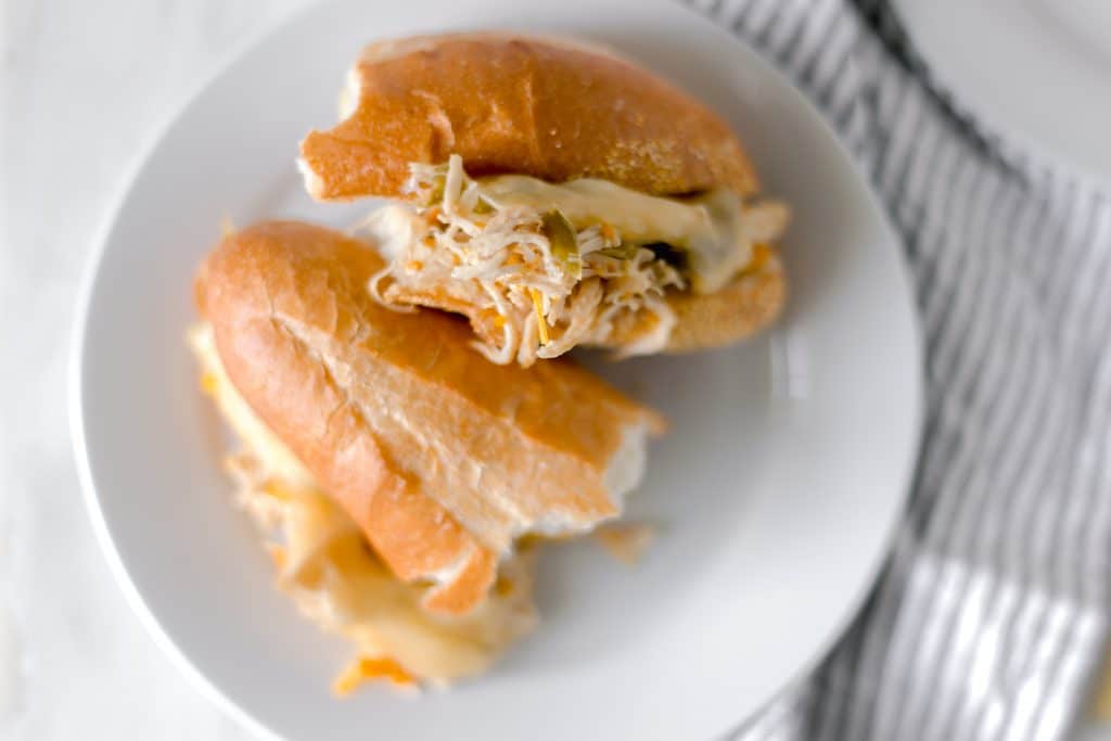 chicken sandwich cut in half on white plate