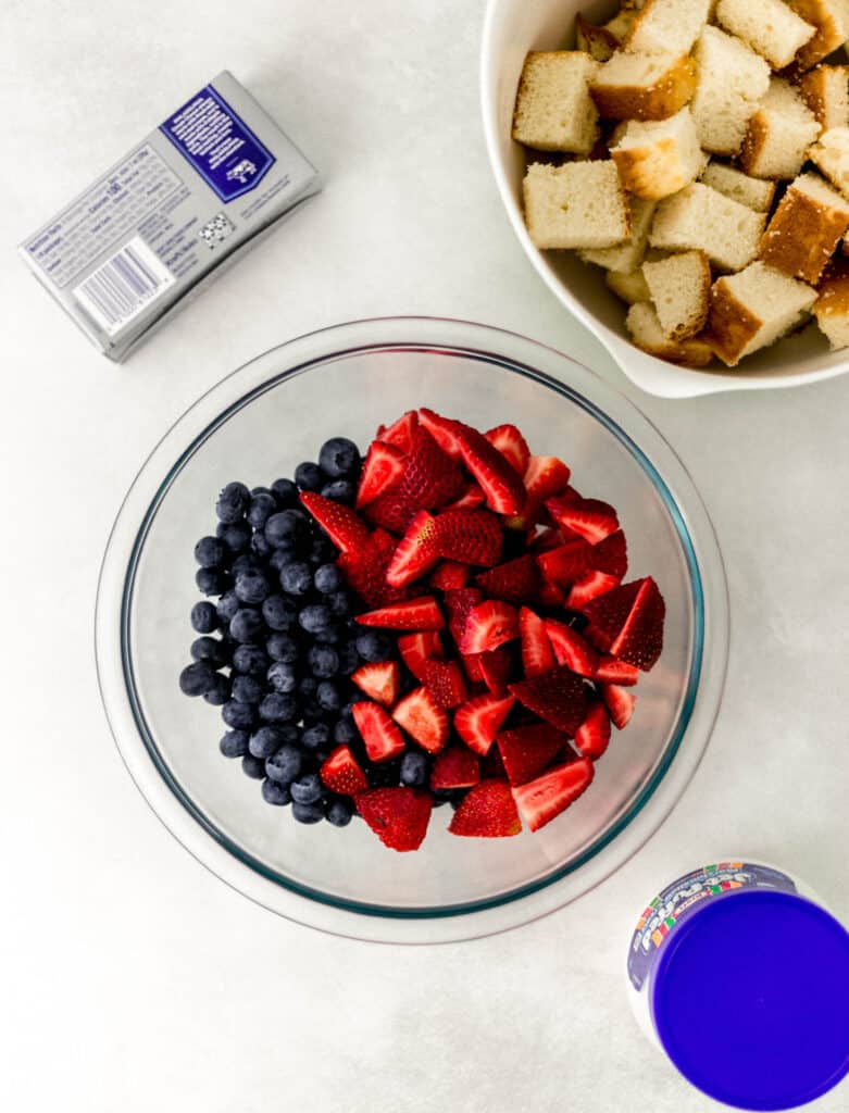 ingredients needed to make berry trifle in separate containers. 