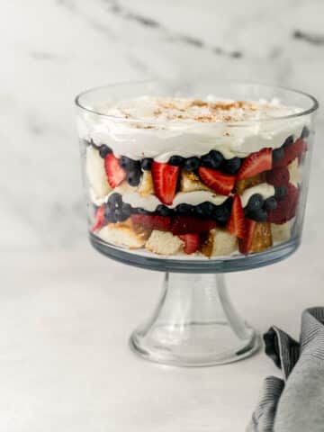 close up side view of trifle next to cloth napkin