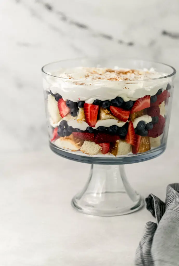 close up side view of trifle next to cloth napkin
