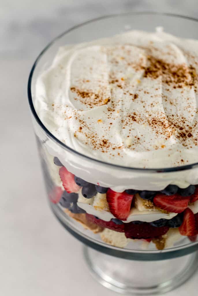 trifle topped with whipped topping and sprinkle of ground cinnamon