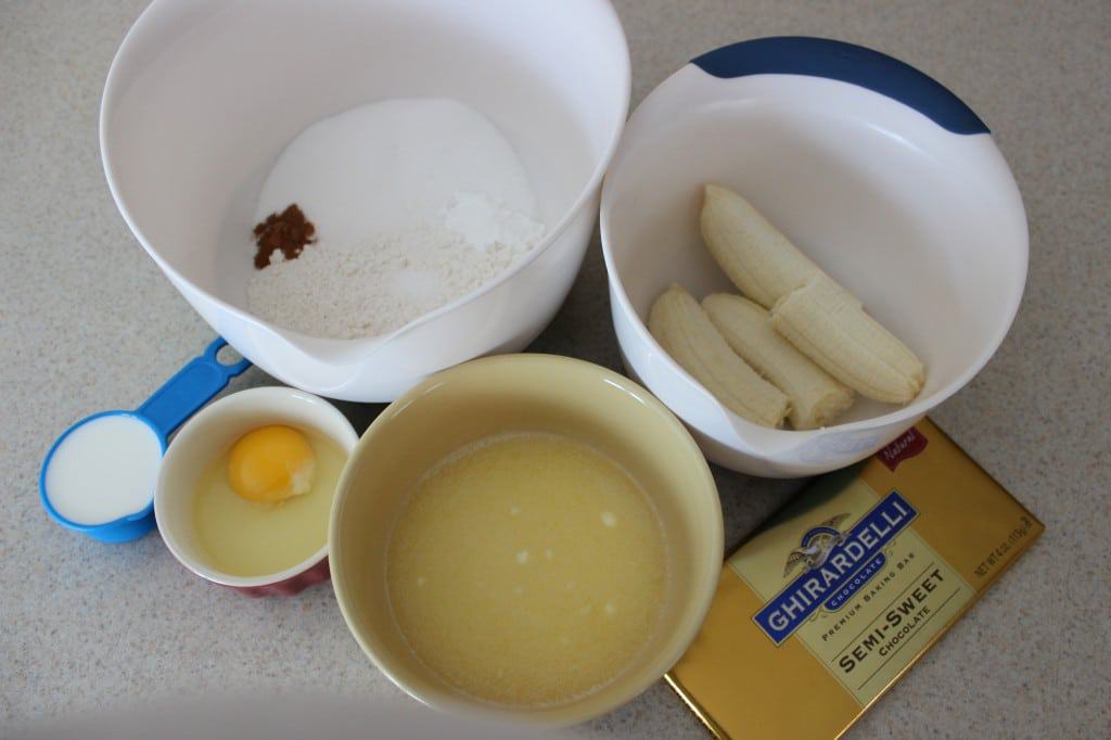 ingredients to make chocolate banana muffins in separate bowls. 