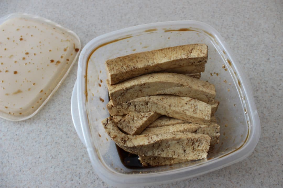 tofu and sauce in plastic container 