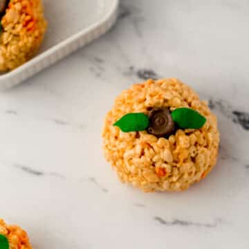 pumpkin shaped rice krispie treats on marble surface