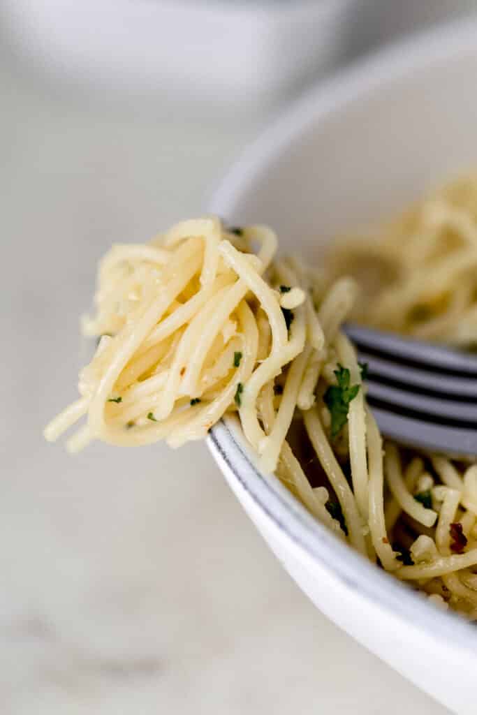 fork over bowl with pasta on it 