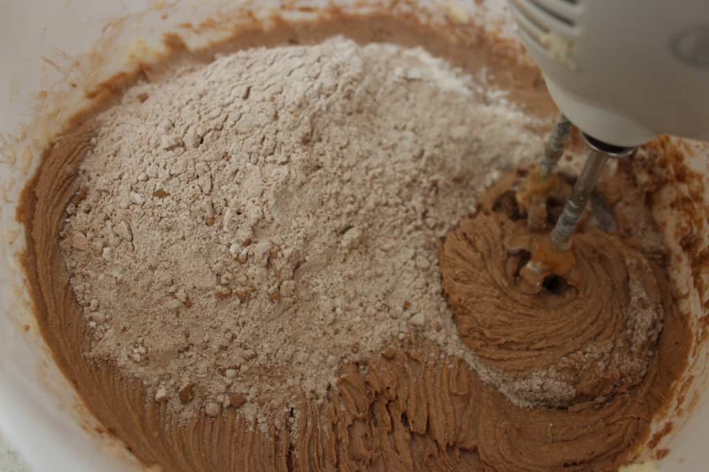 view of cocoa being added to Chocolate Sour Cream Pound Cake mixture 
