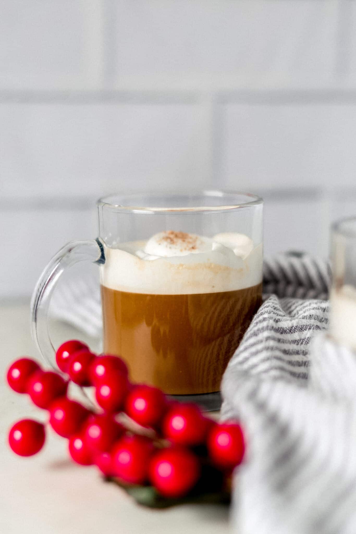 side view gingerbread latter in clear glass mug