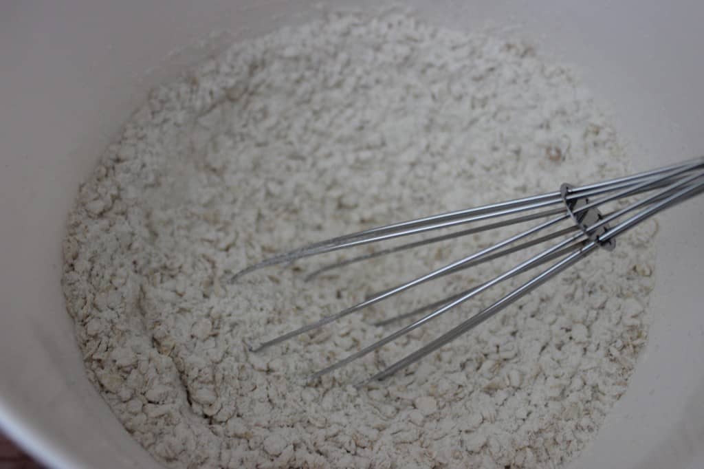 whisk in white mixing bowl with dry ingredients for scone recipe