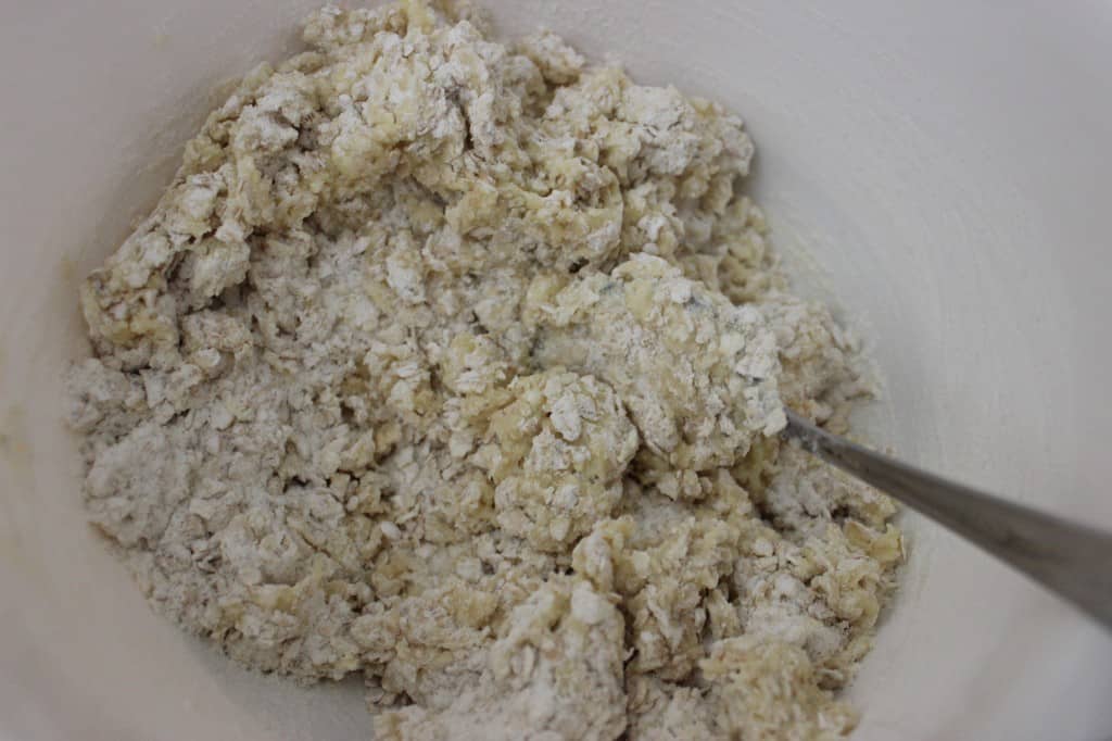 scone mixture in white mixing bowl with fork 
