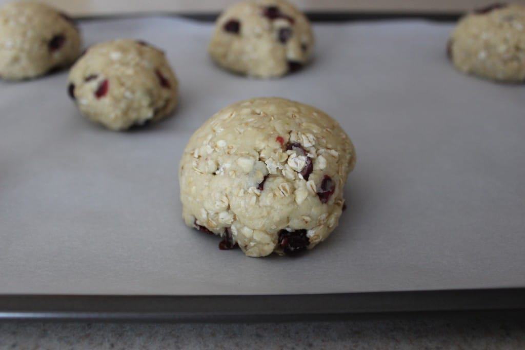 unbaked cherry oat scones on parchment-lined baking sheet 