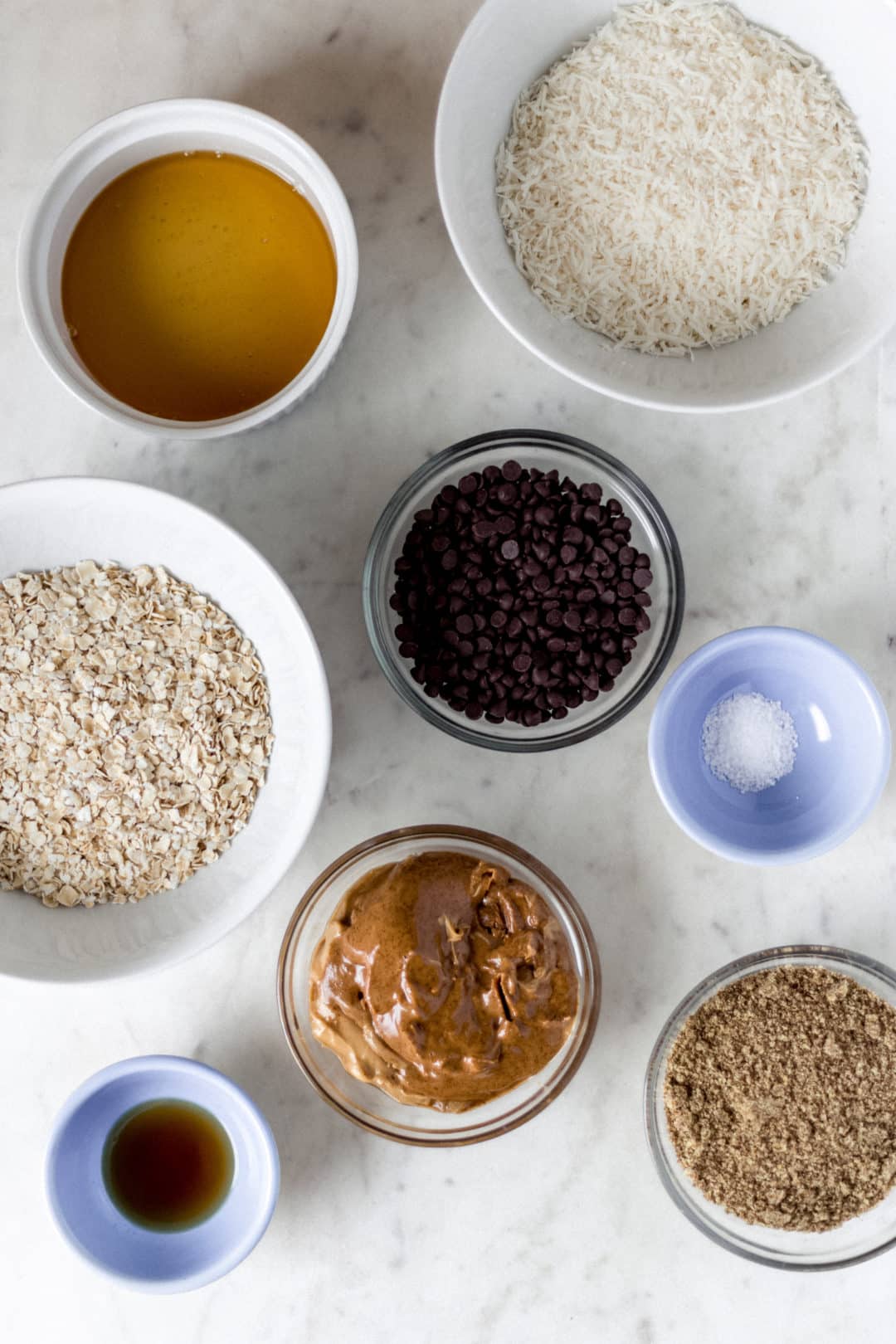 ingredients needed to make energy bites in separate bowls 