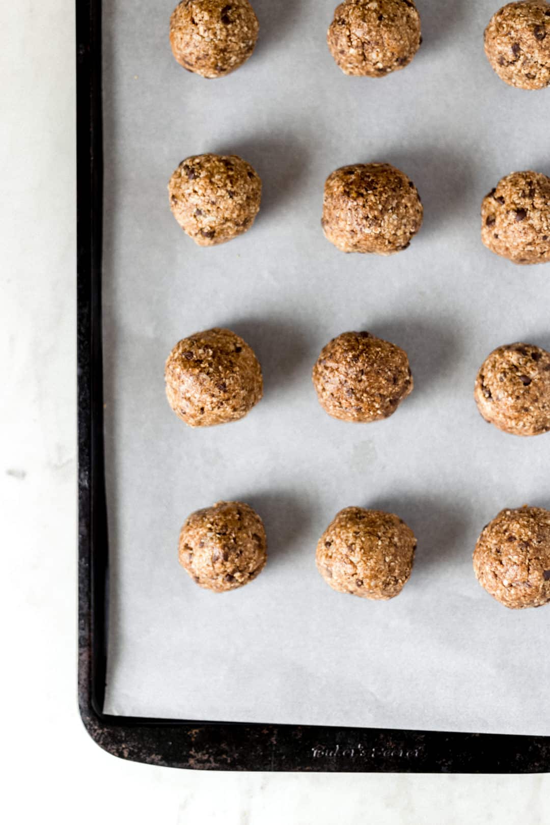 balls on parchment lined baking sheet 