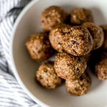 finished energy bites stacked on top of each other in large white bowl