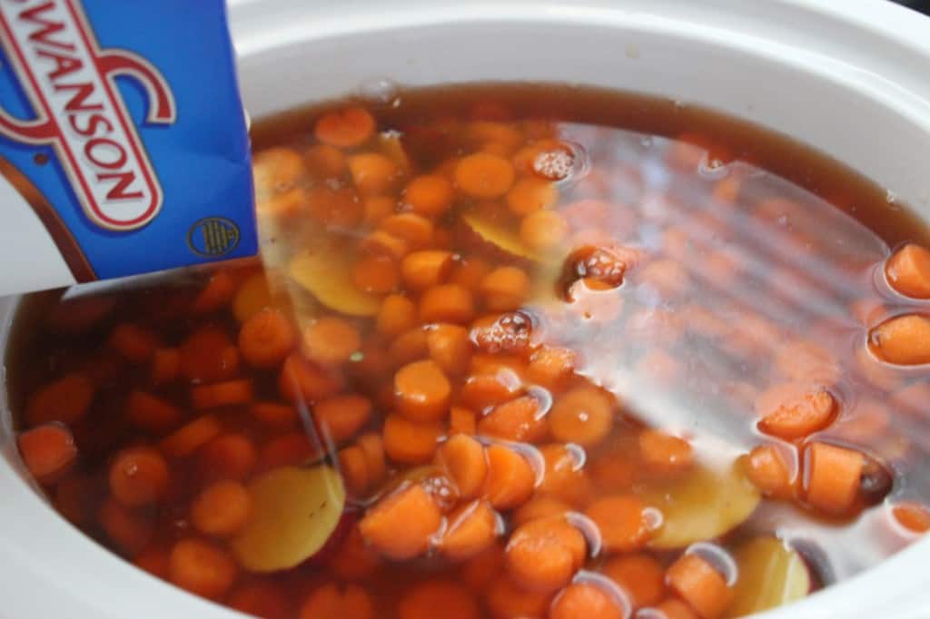 vegetables and broth added to slow cooker 