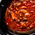 Overhead view of finished beef stew in crock pot.