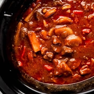 Overhead view of finished beef stew in crock pot.